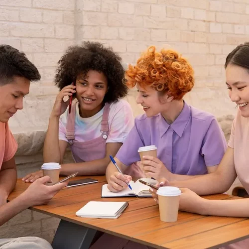 medium-shot-friends-sitting-table_23-2149103126