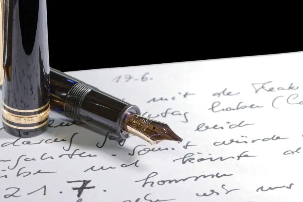 A fountain pen writing a letter, representing French correspondence and documents prepared for translation