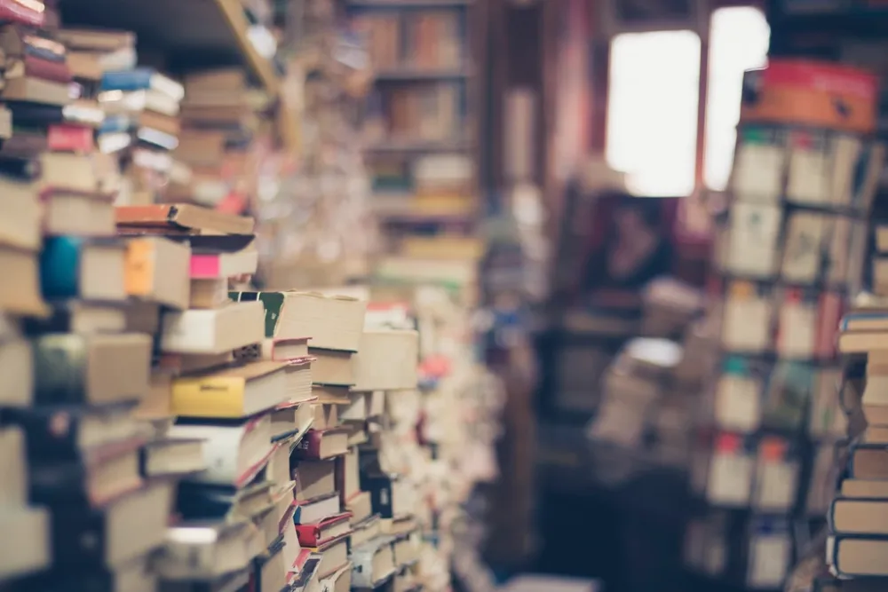 A stack of books, representing Portuguese documents and publications prepared for translation